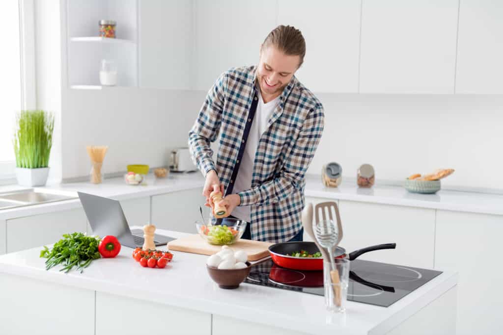 man is cooking modern kitchen