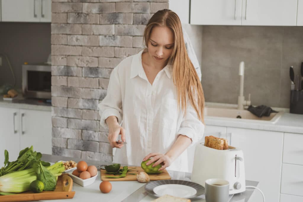 young beautiful girl kitchen prepares healthy food